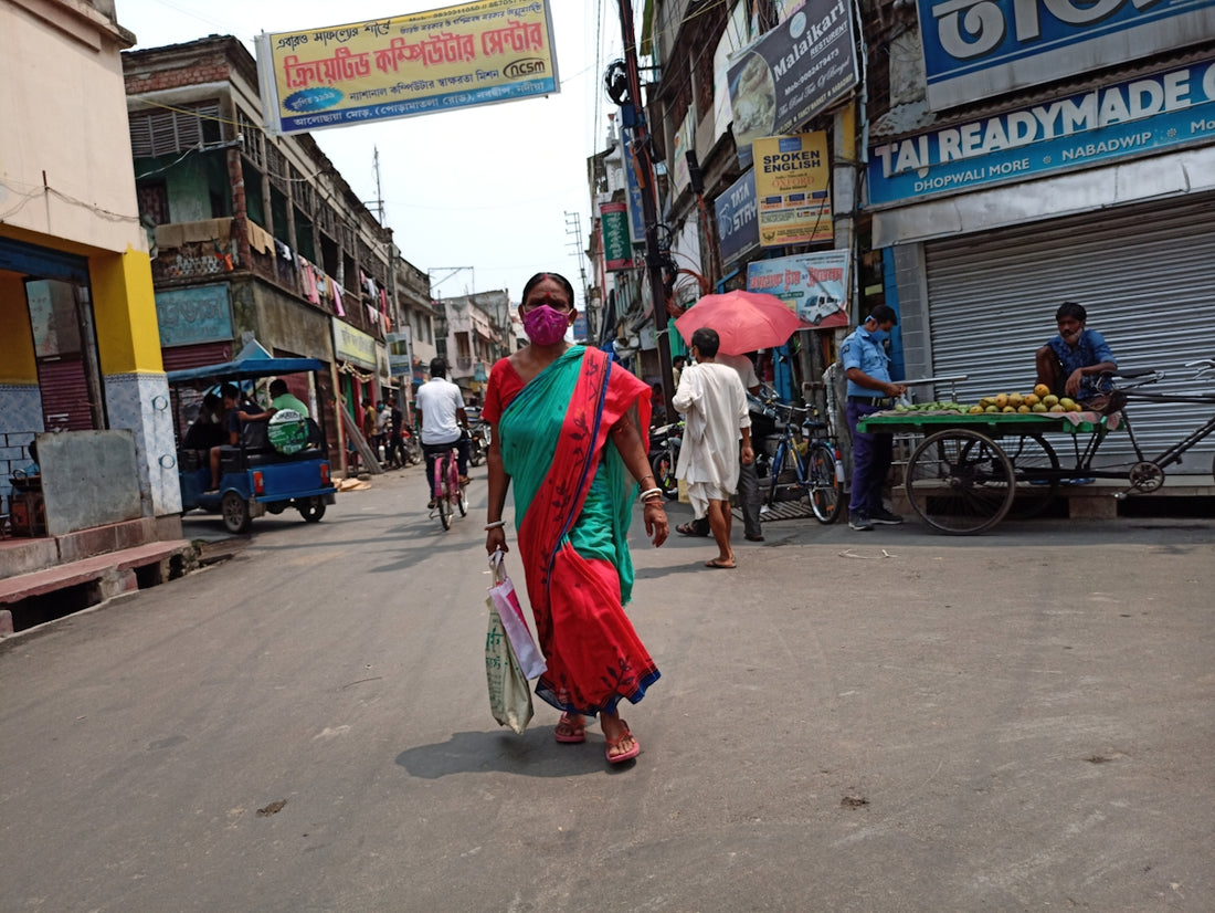 man in red robe walking on street during daytime