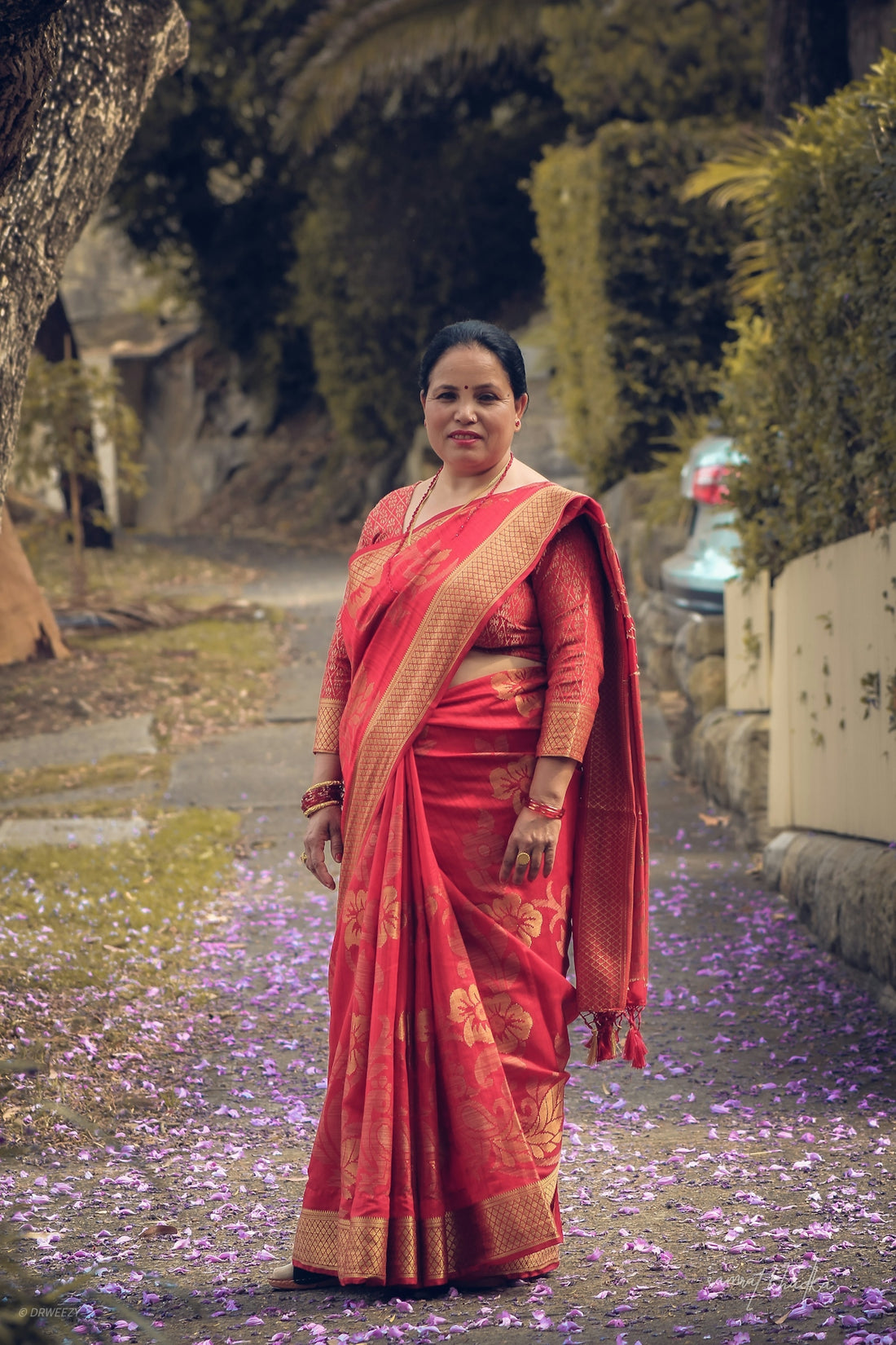 woman in red long sleeve dress standing on purple flower field during daytime
