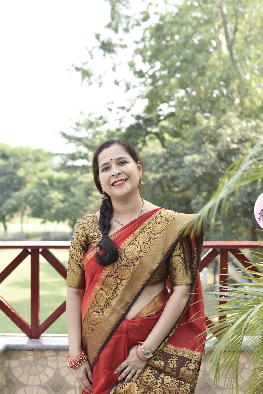 a woman in a red and gold sari