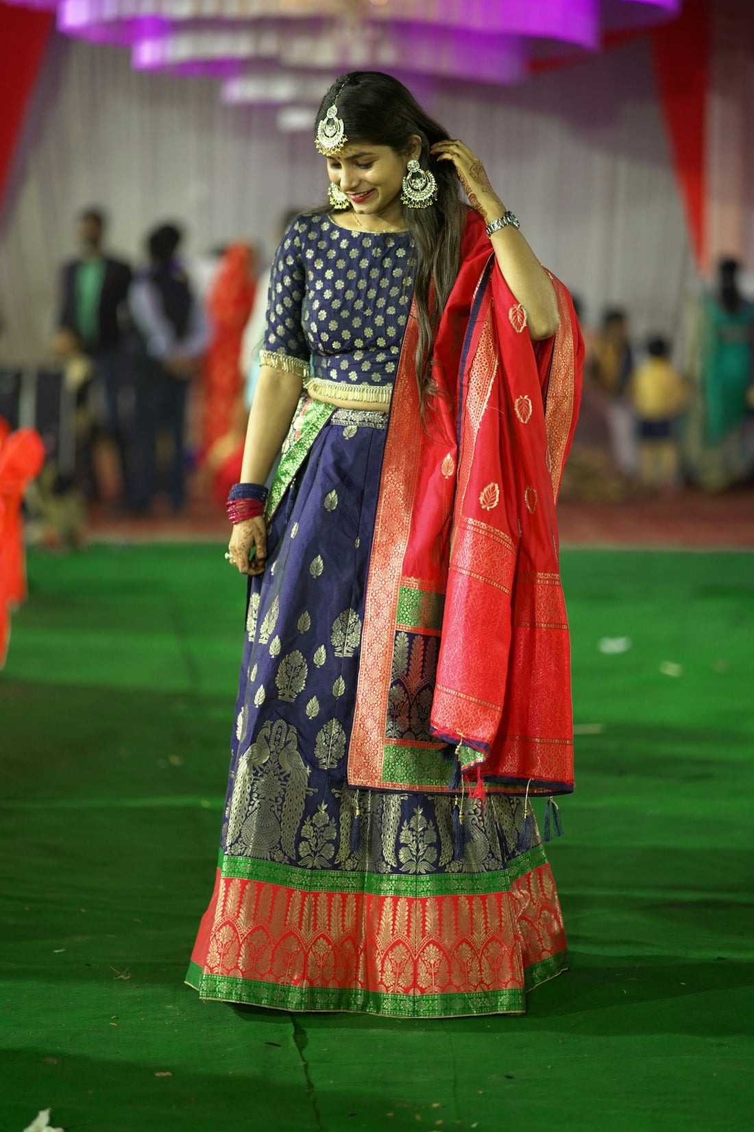 a woman in a blue and red lehenga