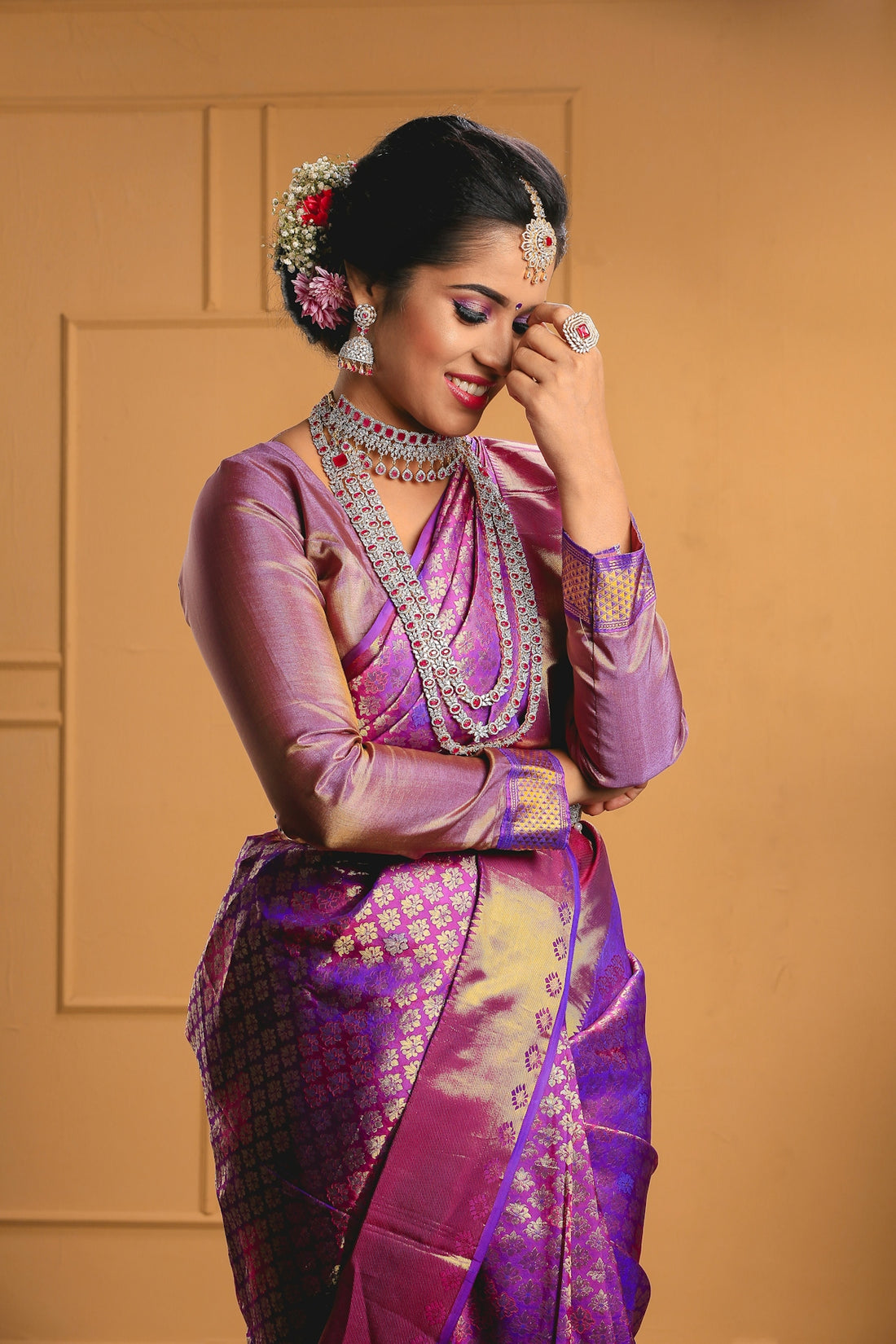 a woman in a purple and gold sari