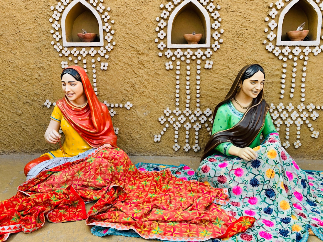 two women sitting on a bed