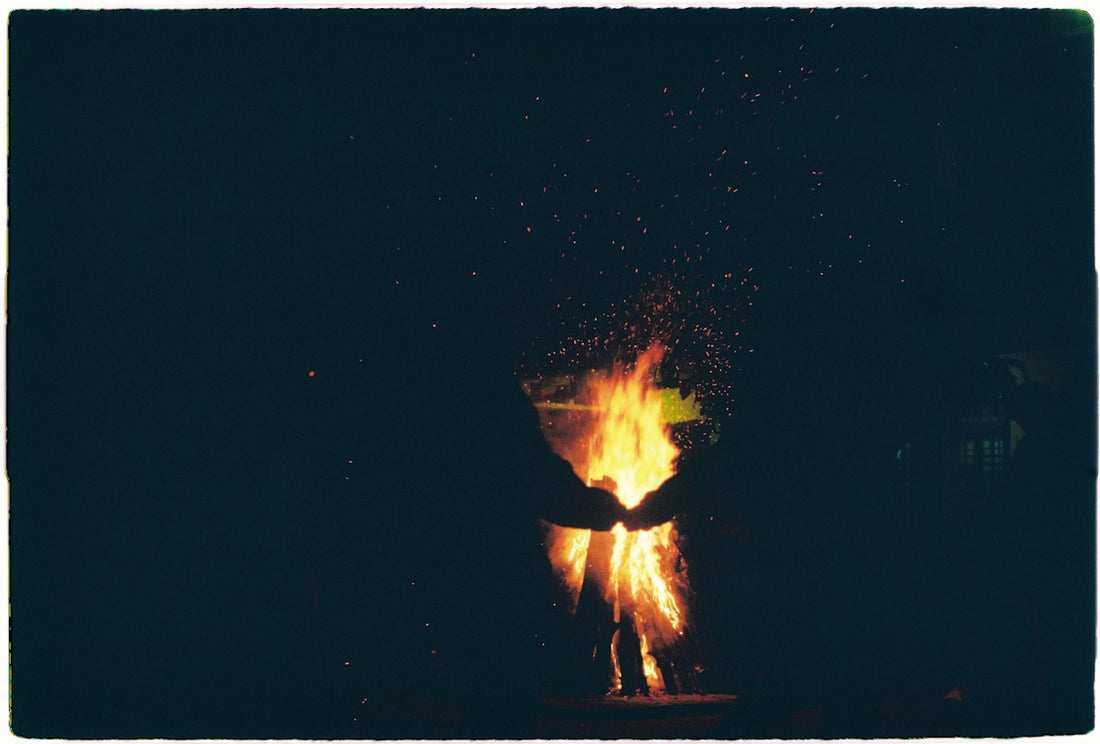 a person standing in front of a fire