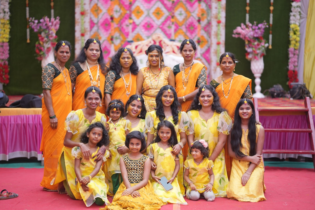 A group of women in yellow dresses posing for a picture