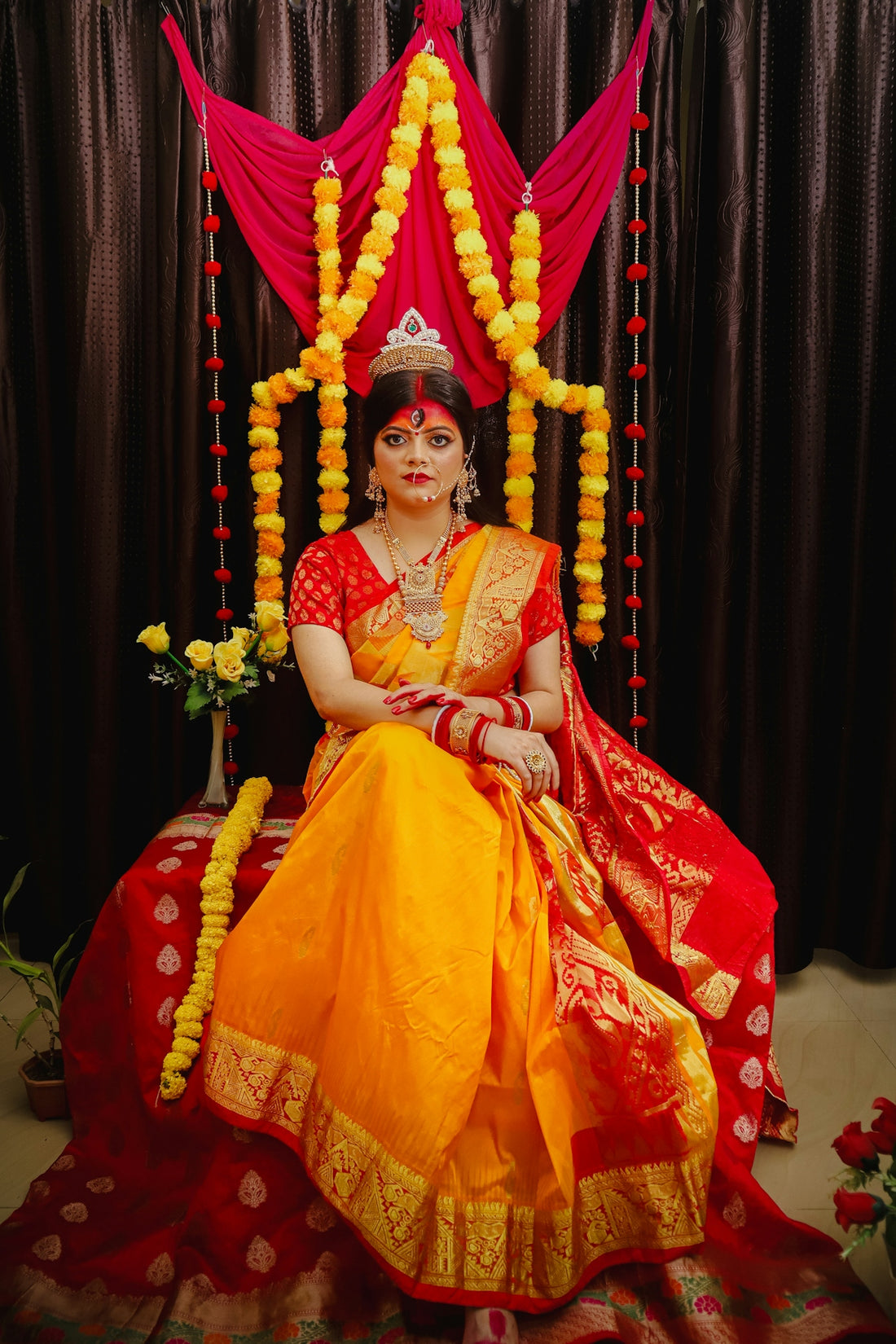 A woman in a yellow and red outfit sitting on a chair