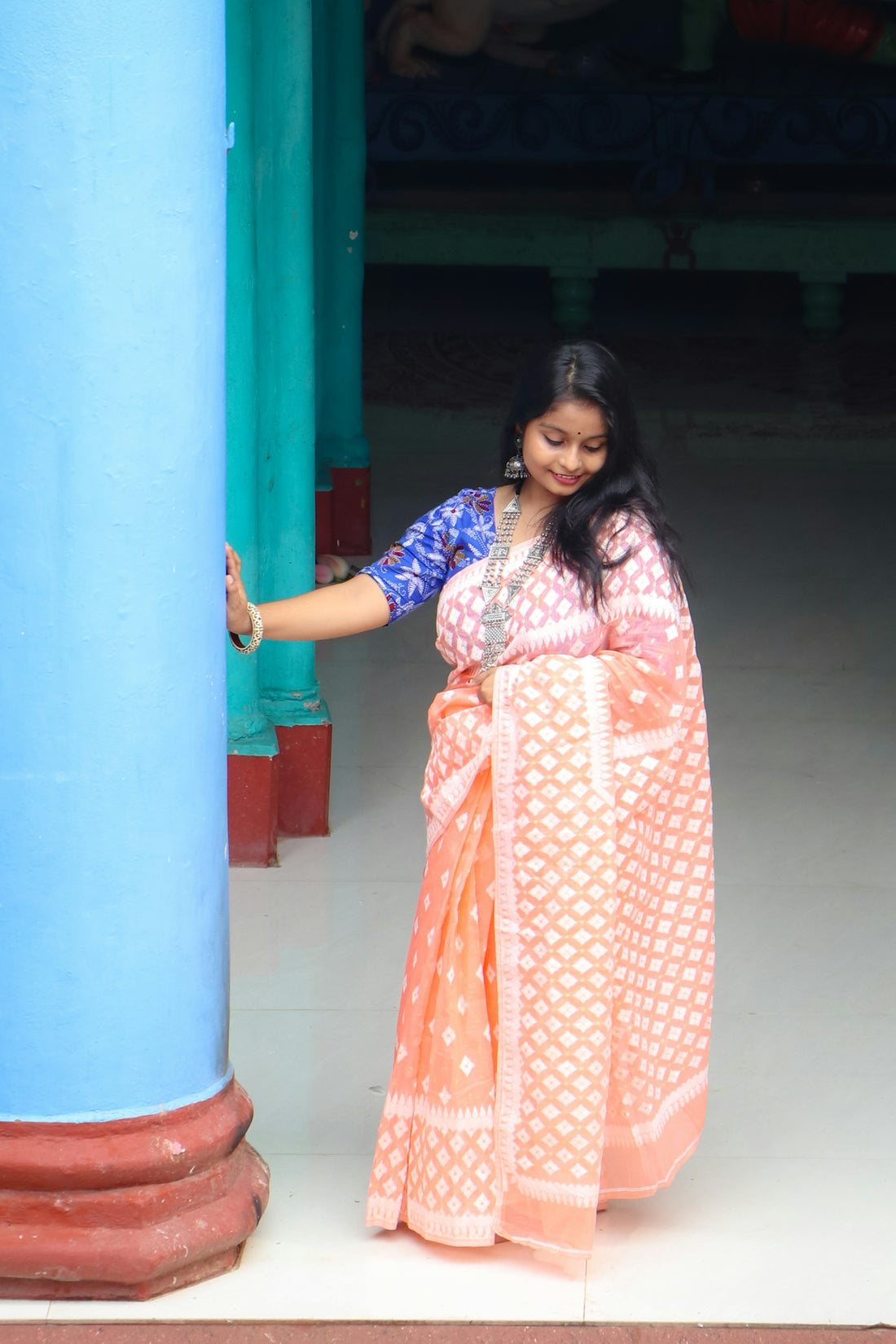 A woman in a pink and blue sari