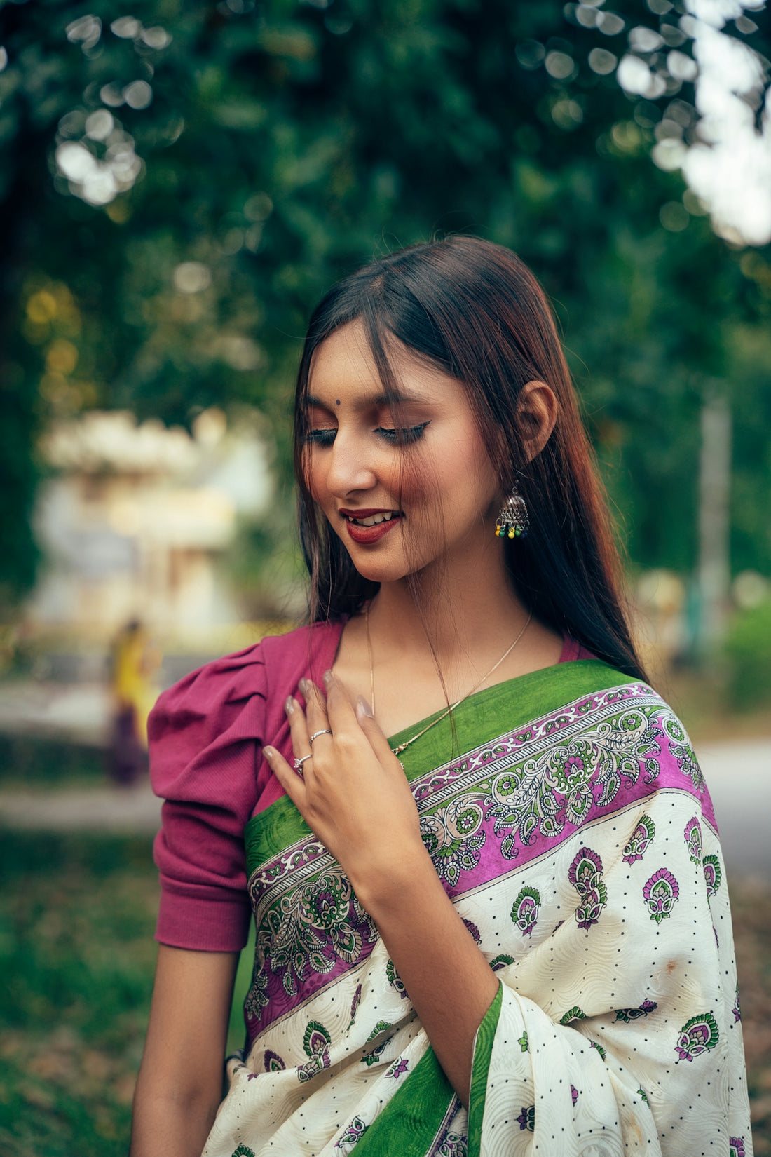 A woman in a green and white sari