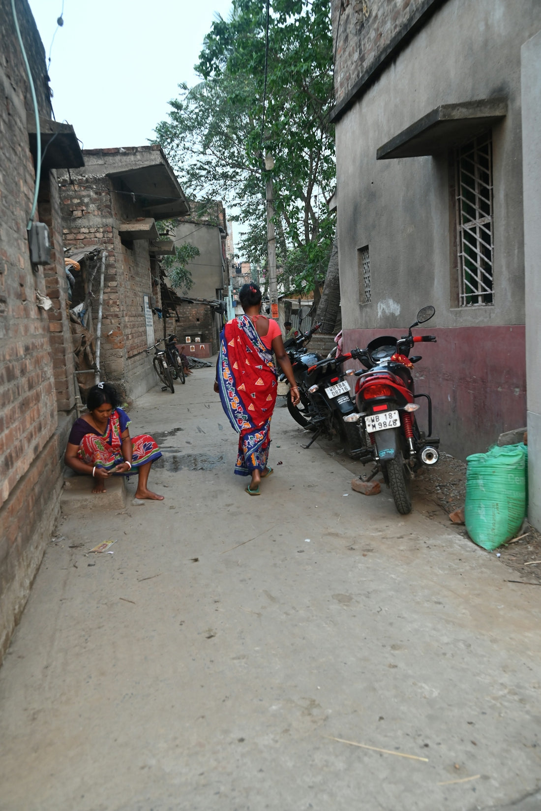 Women walk in a narrow street in india.