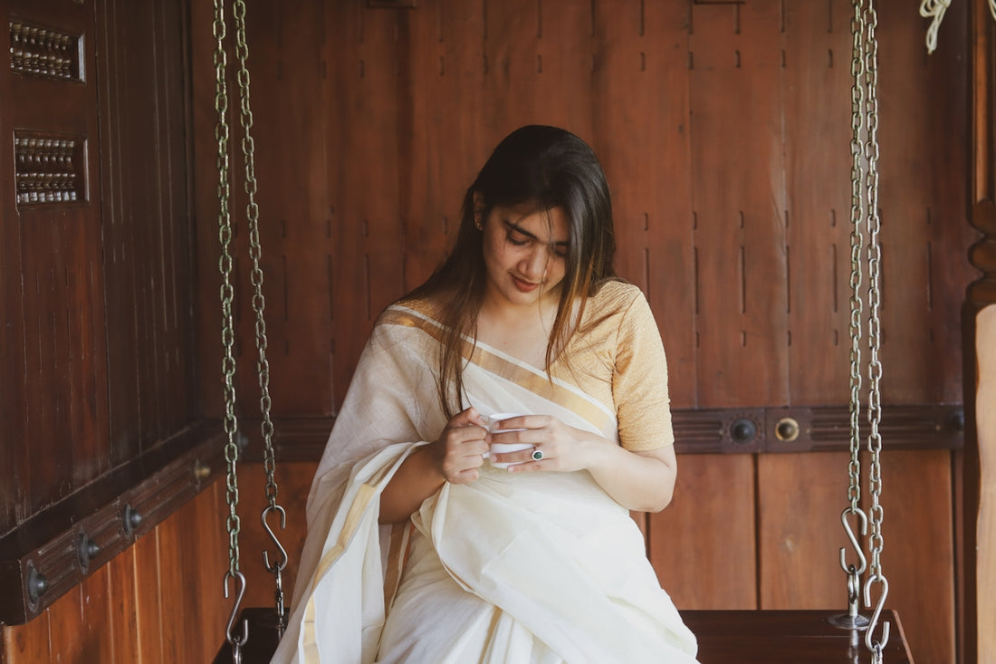 Woman in saree sitting on swing.