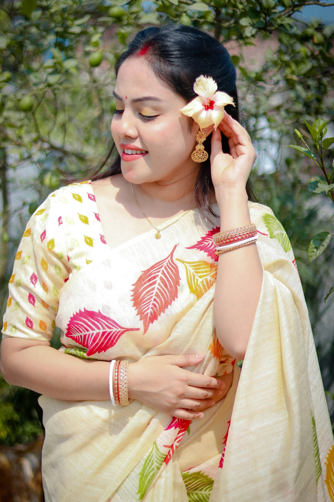 Beautiful woman smiles while holding a flower.